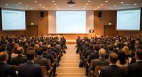 Business conference presentation in modern auditorium with professional audience attending corporate seminar or educational workshop event.