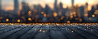 Empty wooden deck with blurred city skyline at sunset, golden bokeh lights creating magical atmosphere on rustic planks. For backgrounds and composites.