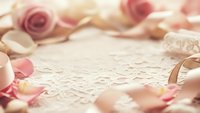 Romantic wedding rings on delicate lace with soft pink rose petals creating elegant bridal background for love celebration and marriage ceremony invitations.