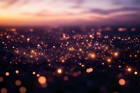 Magical glowing bokeh lights scattered across dark background with warm orange and purple sunset colors create dreamy atmospheric effect for festive designs.