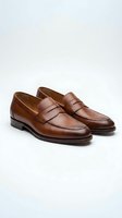 Classic brown leather penny loafers isolated on white background for business casual footwear and fashion design projects.