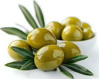 Fresh green olives with olive branch leaves on white background for Mediterranean cuisine and healthy cooking recipes.