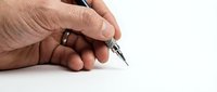 Senior man hand holding elegant black pen ready to write on white paper surface for business documents and correspondence.