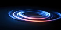Glowing spiral light trails with blue and pink neon colors swirling on dark background create dynamic motion effect for technology and abstract designs.