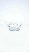 Clear water splash forming a crown shape in a glass container isolated on white background, suitable for beverage, freshness, and purity concepts.