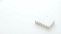 Stack of white paper napkins on clean background for restaurant and catering supplies.
