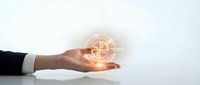 Business professional hand holding glowing digital bitcoin cryptocurrency symbol with network connections representing blockchain technology and finance.