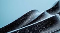 Abstract black wavy paper layers with white speckled texture creating dynamic curves and shadows against light blue background, modern minimalist design element.