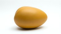 Golden yellow oval egg shape isolated on white background for modern design projects and creative applications.