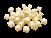 Diced raw potato cubes pile, isolated on transparent background, ready for food design, menus, recipe cards, stickers, print on demand, and culinary clipart use.