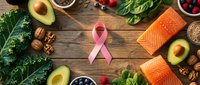 Flat lay arrangement of fresh salmon, avocado, nuts, berries, and leafy greens surrounding a pink awareness ribbon on rustic wood surface for health and nutrition content.