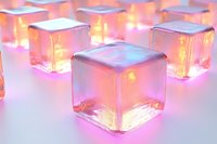 Glowing transparent glass cubes with warm golden light emanating from within, creating magical luminous effect on white surface for modern design concepts.