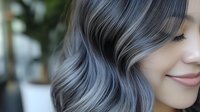 Young woman with trendy silver gray hair color showing modern hair styling and coloring techniques for beauty salon services.