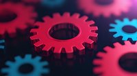 Red and blue metallic gears on dark background with selective focus effect creating depth and mechanical concept for business teamwork and technology innovation.
