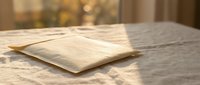 Wooden flooring samples displayed on marble surface with warm natural lighting for interior design and home renovation projects.