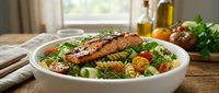 Grilled salmon fillet with fresh vegetables and herbs in white bowl, healthy lunch or dinner meal preparation.