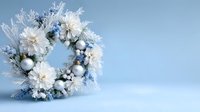 Elegant winter wreath with white poinsettias, silver ornaments, and frosted branches on light blue background. Perfect for seasonal holiday decor.