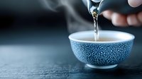 Pouring hot tea into traditional blue ceramic cup with delicate pattern. Steam rising creates atmospheric mood on dark background. Serene moment captures essence of tea ceremony.