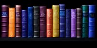 Row of vintage hardcover books with ornate spines in various colors arranged on dark shelf, creating classic library atmosphere for education and literature concepts.