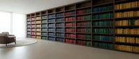 Modern home library with colorful book collection organized on wooden shelves in minimalist living room interior for reading and study spaces.