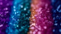 Vibrant macro shot of colorful crystal formations with purple, blue and pink hues creating abstract bokeh effect. Natural mineral structure with sparkling light reflections.
