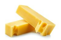 Two pieces of yellow Swiss cheese with holes showing texture and freshness, isolated on white background for food packaging and menu design.
