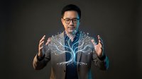Asian businessman with glasses presenting holographic tree technology concept with glowing neural network branches for innovation and growth presentations.