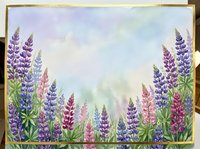 Watercolor lupine flowers in purple and pink hues create a dreamy garden border with soft pastel sky background for spring botanical designs.