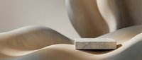 Minimalist wooden cube floating above open palm in soft natural lighting creating zen meditation and mindfulness concept for wellness design.