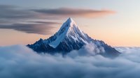 Majestic snow-capped mountain peak emerging through clouds at sunrise with dramatic pink and orange sky creating breathtaking alpine landscape scenery.