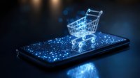 Glowing shopping cart on smartphone screen with blue light effects and sparkles, representing digital commerce and mobile shopping technology.