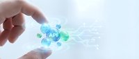 Hand holding glowing API icon with digital network connections and data flow visualization for software development and technology integration concepts.