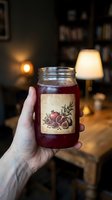 Hand holding glass jar of homemade pomegranate jam with vintage label in cozy kitchen interior with warm lighting for artisan food packaging design.