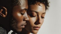 Intimate portrait of young African American couple with eyes closed in tender moment. Man and woman sharing peaceful connection in soft natural light.