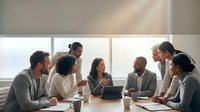 Diverse business team collaborating in modern conference room with natural lighting during productive meeting session.