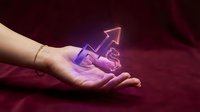 Young adult female hand holding glowing purple upward arrow symbol against deep burgundy background, representing growth, success, and financial progress for business and investment concepts.