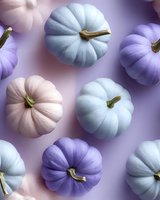 Pastel colored pumpkins in purple, pink and blue shades arranged on purple background, top view composition for seasonal autumn and halloween design.