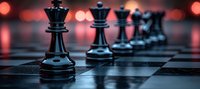 Black chess pieces on board with dramatic red bokeh lighting in background, strategic game concept focused on queen and pawns in dark moody atmosphere.