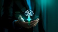Businessman holding glowing digital tree hologram with roots in dark environment representing growth, innovation, technology and sustainable business development.