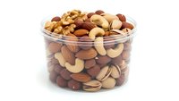 Mixed nuts assortment in clear plastic container with almonds cashews walnuts and hazelnuts isolated on white background for healthy snacking concepts.