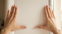 Woman's hands with manicured nails framing empty white space, suitable for product placement, advertising, and promotional content layouts.
