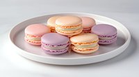 Colorful French macarons in pastel pink, peach and purple shades arranged on round white ceramic plate against light background, sweet dessert photography.