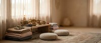 Serene meditation space with wooden tea set, cushions and natural lighting creating peaceful zen atmosphere for mindfulness practice and relaxation.