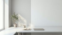 Minimalist white workspace with laptop, coffee cup and olive plant on clean desk near window with natural light for modern office interior design.