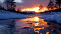 Dramatic winter sunset reflects golden light on partially frozen lake surface, with snow-covered shores and silhouetted pine trees against purple mountain backdrop.