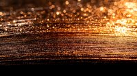 Glowing copper metallic surface with golden bokeh lights and textured striations creating dramatic abstract background for luxury design projects.