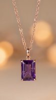 Rose gold chain necklace featuring rectangular amethyst gemstone pendant with warm bokeh background, suitable for jewelry and luxury product photography.