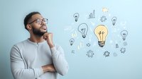 Young African American businessman in glasses and grey sweater thinking creatively with illustrated light bulbs and business icons, concept of innovation and ideas.