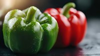 Fresh green and red bell peppers with water droplets on kitchen counter ready for cooking and meal preparation.