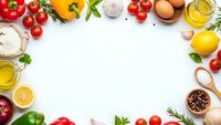 Fresh cooking ingredients frame with vegetables, herbs, olive oil and spices on white background. Culinary border layout for recipe design and food preparation.